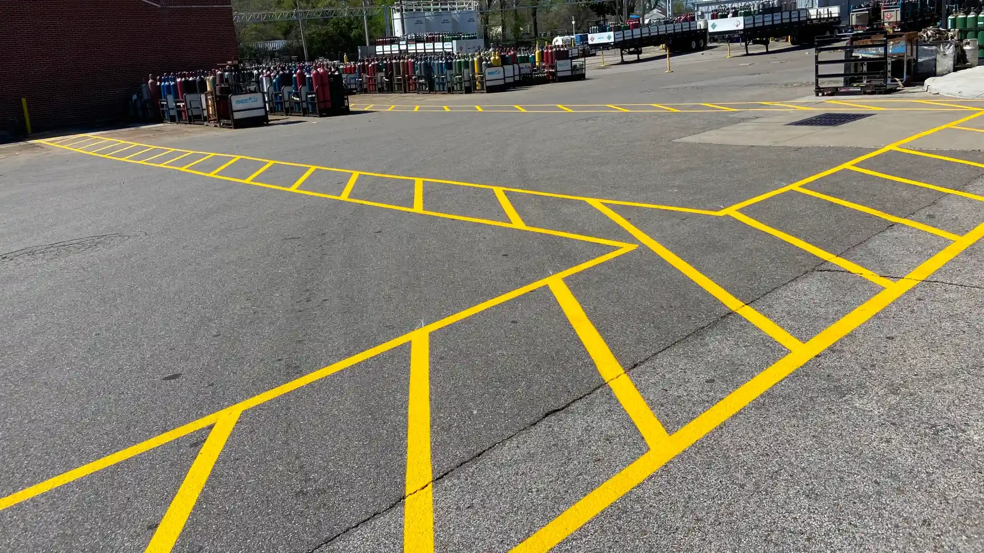 Professional parking lot striping with yellow crosshatch no-parking zones in Memphis, TN